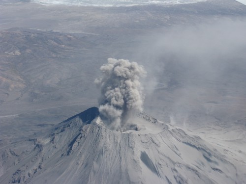 Smoking volcano somewhere in the Andes - taken during flight from Santiago to Bogota