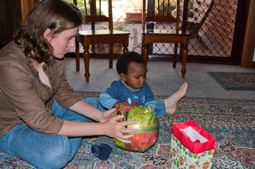 Leanne helps Andres unwrap some Christmas presents