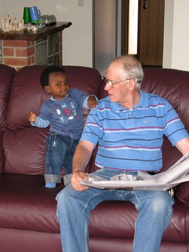 Andres reading the paper with Grandpa